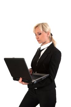 Blond girl working at a laptop isolated on white.