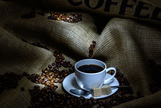 Coffee cup, beans and burlap. still life