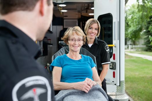 Portrait of a healthy senior citizen on an ambulance stretcher