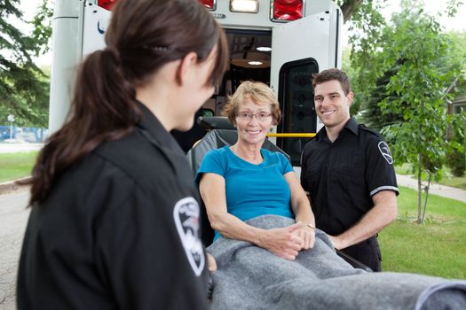 Senior woman looking at the camera while on a stretcher