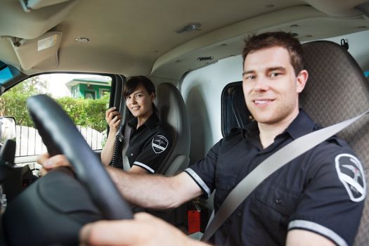 Portrait of man and woman paramedic team, shallow DOF critical focus on female