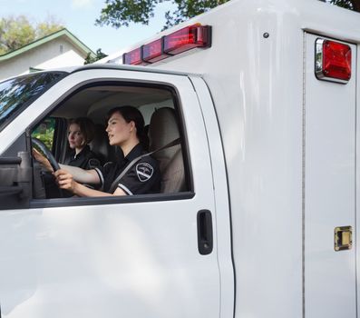 Two female ambulance professionals in a vehcile