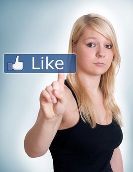young blonde woman pressing a like button 