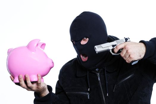 man with a gun and piggy bank in studio