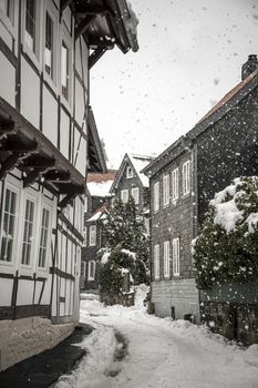 Side street with half-timbered houses in the winter with snow