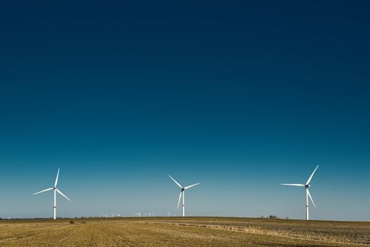 Windmills in northern Germany on a field on a sunny day