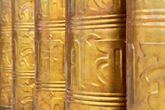 Buddhist prayer wheels decorated in Tibet monastery temple