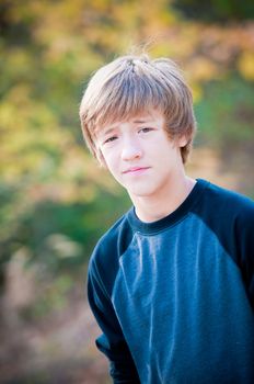 Portrait of cute young teen looking at camera with not much expression on face.