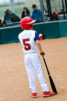 Little league baseball batter on deck.