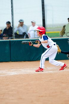 Little league baseball boy about to bunt the ball.