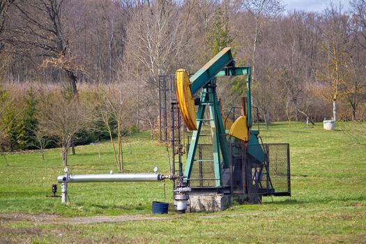 Oil pump in green nature, oilfield in Croatia