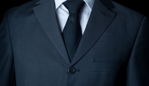 Closeup shot of business suit on a man, over dark background