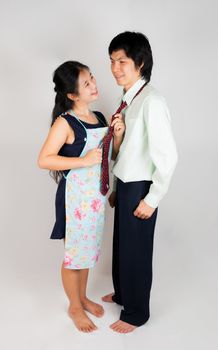 Wife ties husband's necktie with plenty of love