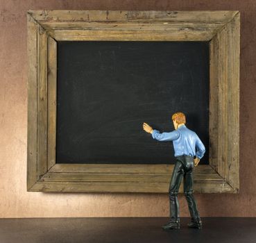 Business person against the blackboard with brown grunge wallpaper