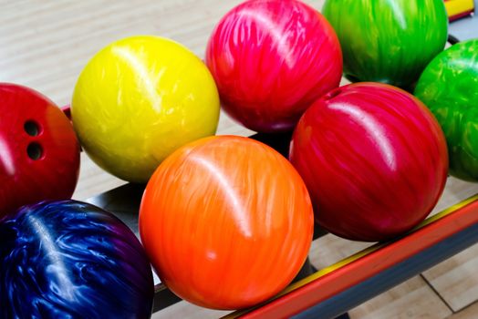 Colorful bowling balls waiting to be chosen