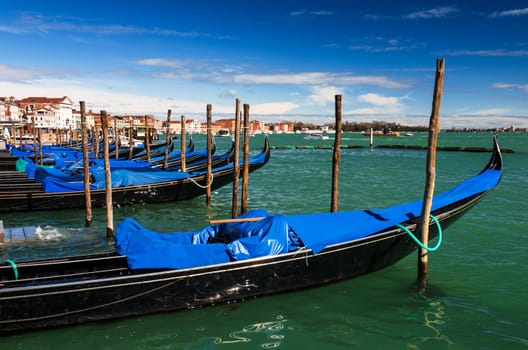 Gondolas on the dock of Piazza San Marco, Venice international landmark of Italy.