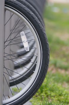 tires with reflector of parked bikes in a city