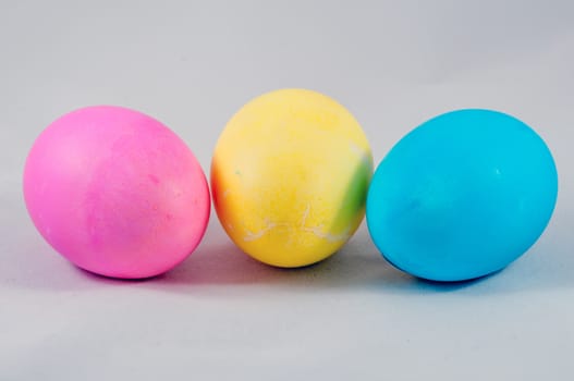three easter eggs pink  blue yellow