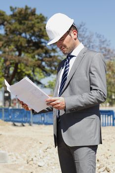 young architect on building site in summer