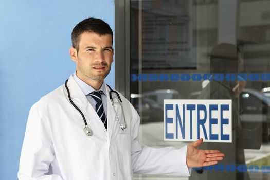 young doctor in front of hospital entry