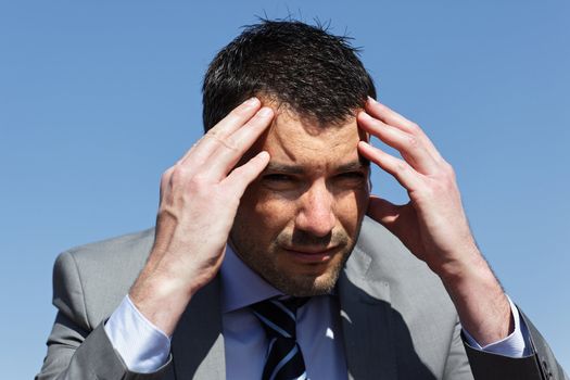 young businessman with head in the hands