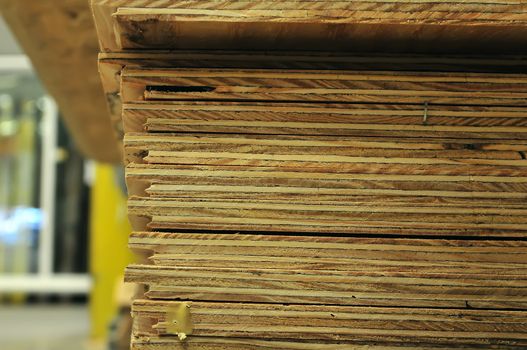 edge of stack of plywood on display for sale at the hardware store