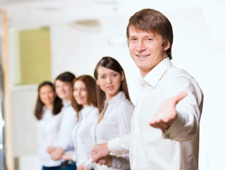 group of people holding hands, man holds out his hand, the concept of teamwork