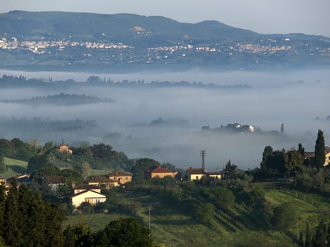 Fabulous landscape of the foggy morning in Tuscany. The valley between Montepulciano and Chiusi