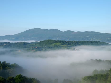 Fabulous landscape of the foggy morning in Tuscany. The valley between Montepulciano and Chiusi