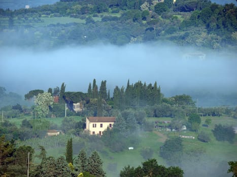 Fabulous landscape of the foggy morning in Tuscany. The valley between Montepulciano and Chiusi