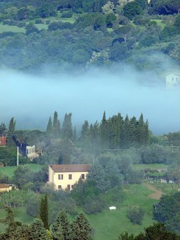 Fabulous landscape of the foggy morning in Tuscany