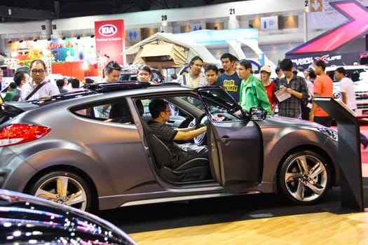 BANGKOK, THAILAND - April 2- Group of people are interested in Sport car in Bangkok international motor show 2013 on April 2, 2013 in Bangkok, Thailand.