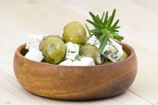 feta cheese and olives with herbs in olive oil