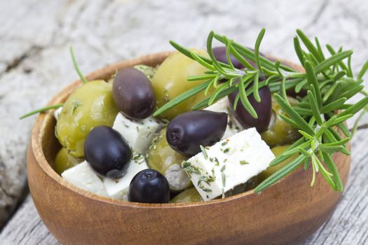feta cheese and olives with herbs in olive oil