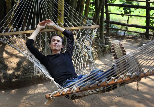 The man relaxs in a hammock