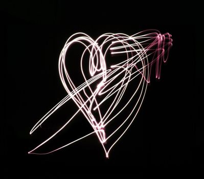Heart and arrow light art on black background