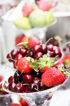 Fruit dessert with strawberry and cherry in glass