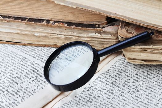 Magnifying glass lying on open book
