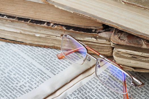 Glasses lying on open book