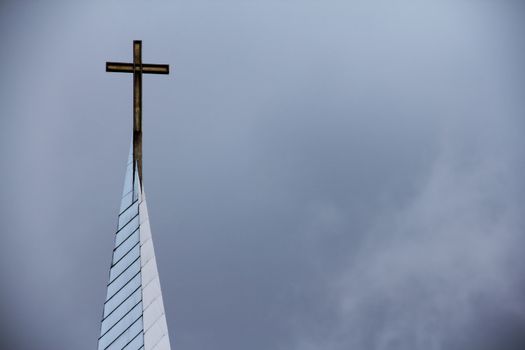Catolic cross on the roof of church