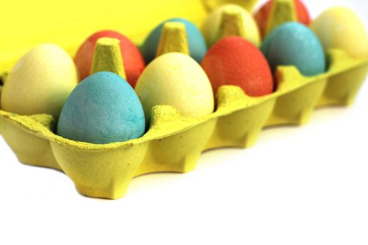 Colorful easter eggs in yellow box on white background