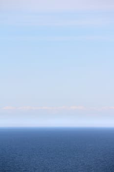Vertical background of blue sea under clear sky