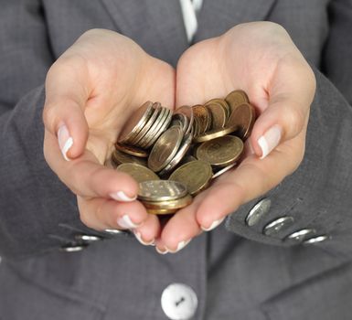 Coins in business woman hands close up