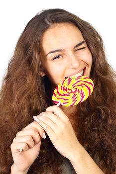 Beautiful long hair girl biting big candy