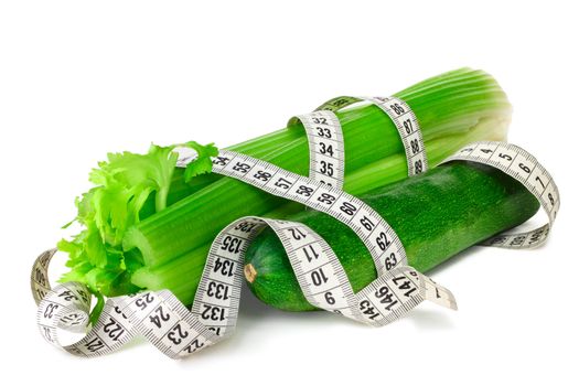 Celery zucchini squash and measure tape diet concept isolated on white