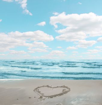 Symbol of heart drawn on sand of sea shore