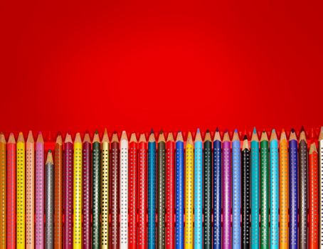 Colorful pencils in red box with copy space
