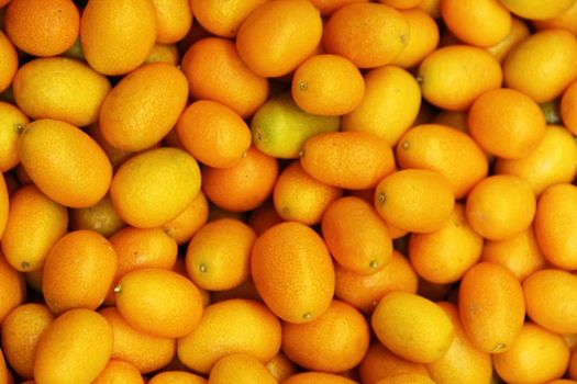 Ripe orange kumquat background close up