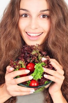 Smiling woman with bowl of fresh salad