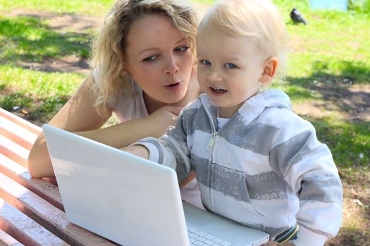 Mother and child with laptop outdoor